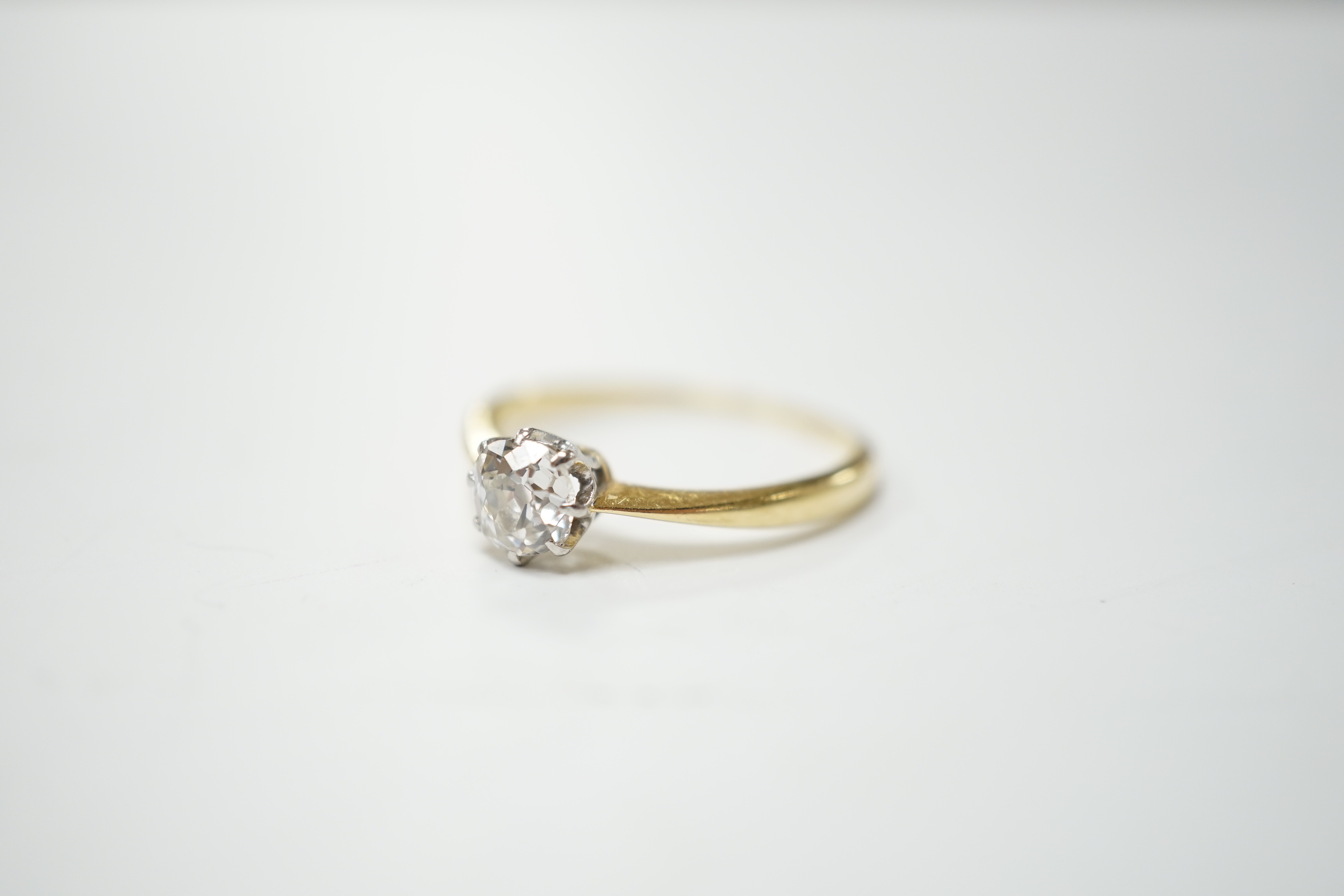 A yellow metal and solitaire diamond ring, stone diameter 5.1mm, size L, gross weight 1.8 grams.